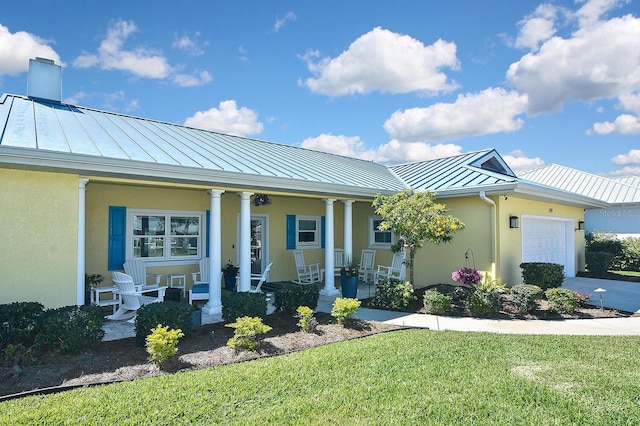 view of front of house with stucco siding, a porch, metal roof, and a standing seam roof