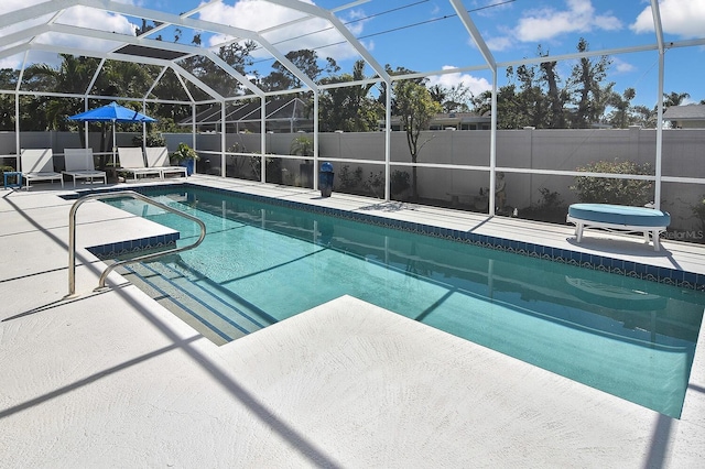 view of swimming pool with a fenced in pool, fence, glass enclosure, and a patio area