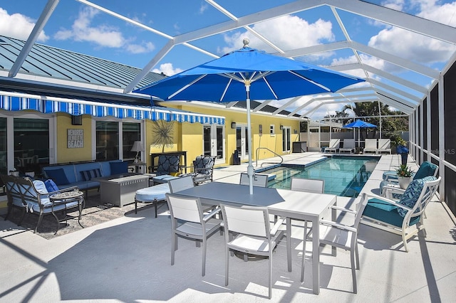 view of swimming pool featuring outdoor dining space, glass enclosure, a fenced in pool, an outdoor living space, and a patio area