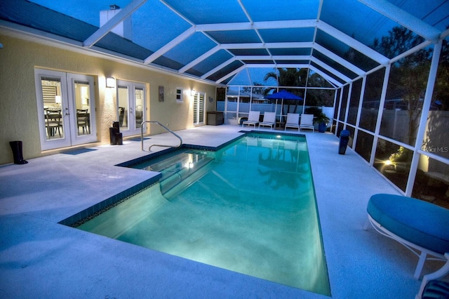 view of pool featuring a patio, a fenced in pool, fence, french doors, and a lanai