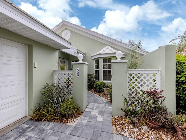 exterior space featuring a garage and stucco siding