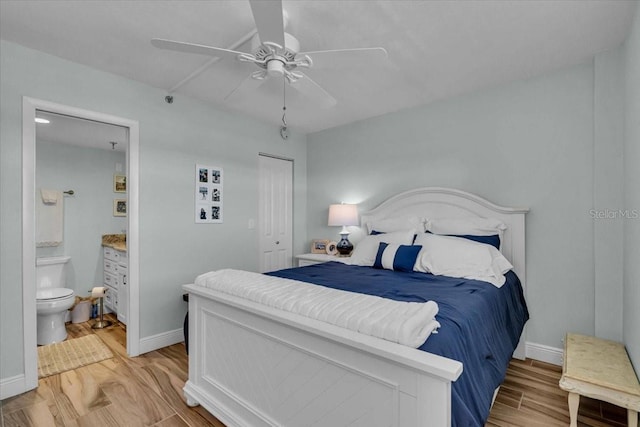 bedroom featuring a closet, connected bathroom, light wood-type flooring, and baseboards