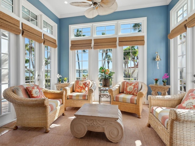 sunroom with ornamental molding, french doors, carpet, and a high ceiling