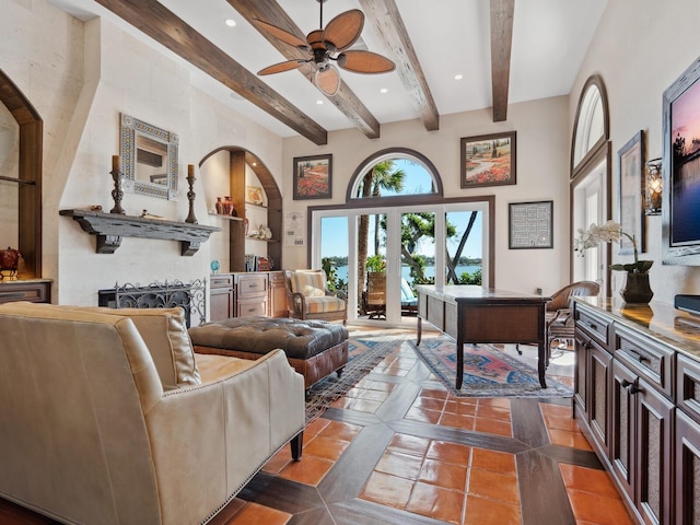 living area featuring ceiling fan, beam ceiling, recessed lighting, a towering ceiling, and dark tile patterned flooring