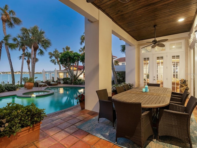 exterior space with ceiling fan, a pool with connected hot tub, a patio area, french doors, and outdoor dining space