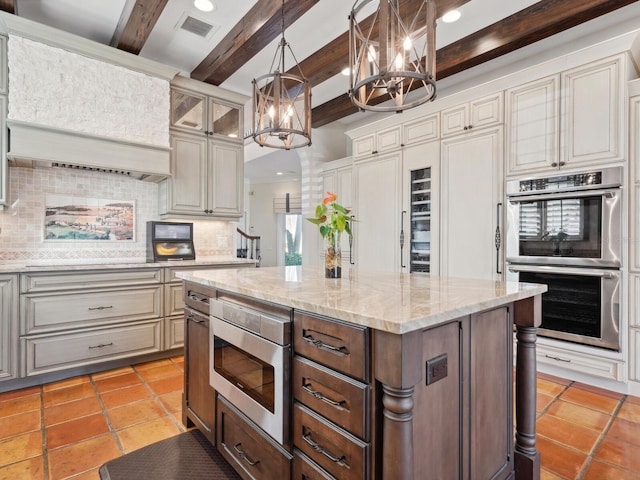kitchen featuring tasteful backsplash, visible vents, stainless steel appliances, a notable chandelier, and beam ceiling