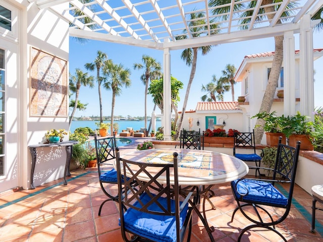 sunroom / solarium featuring a water view