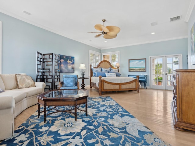 bedroom with light wood finished floors, visible vents, access to outside, and crown molding