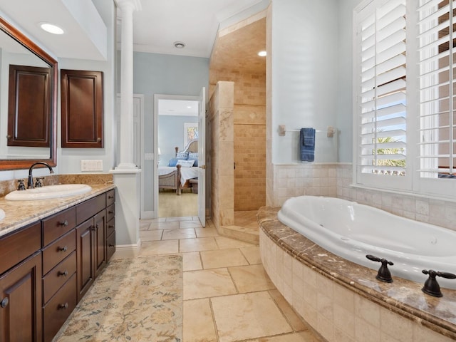 bathroom with a garden tub, decorative columns, ensuite bath, a sink, and double vanity