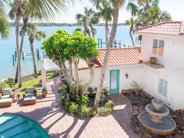 view of patio with a water view