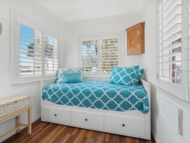 bedroom with baseboards and wood finished floors