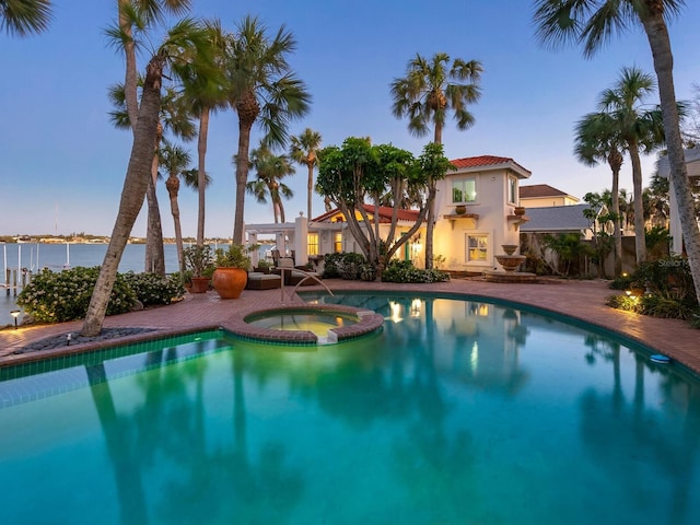 view of swimming pool with a pool with connected hot tub