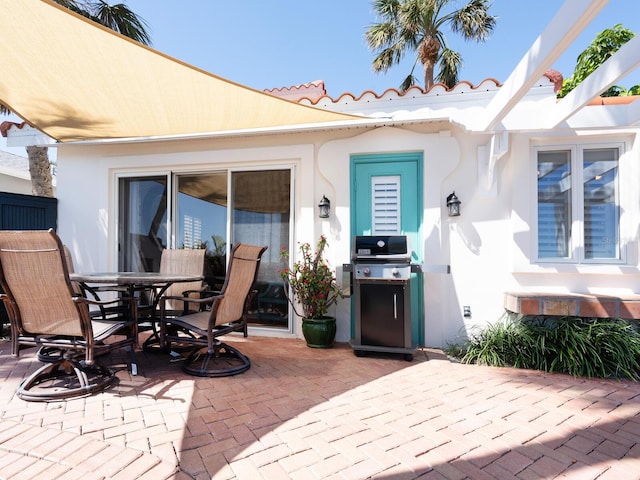 view of patio / terrace featuring outdoor dining area and a grill