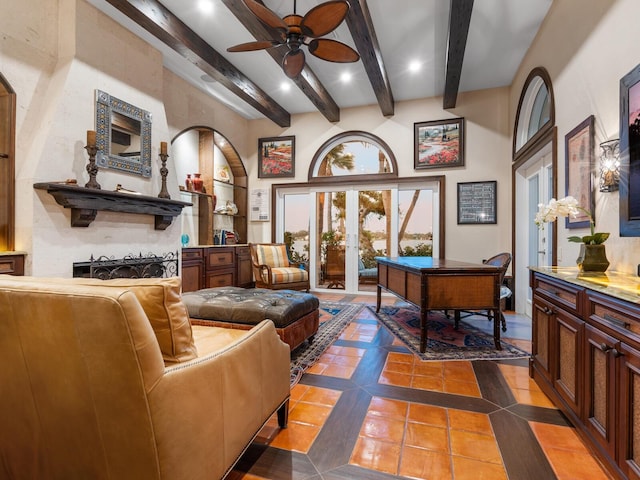 sitting room with dark tile patterned flooring, french doors, beamed ceiling, and ceiling fan