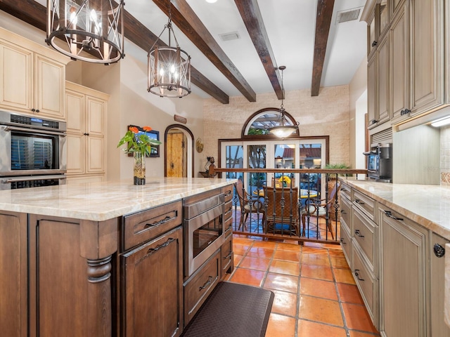 kitchen with beamed ceiling, visible vents, a chandelier, appliances with stainless steel finishes, and cream cabinets