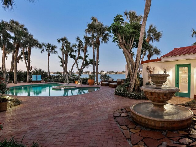 view of pool with a patio and a pool with connected hot tub
