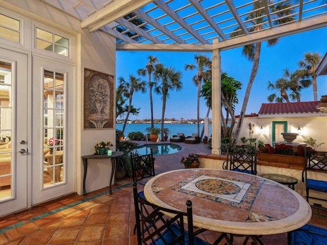 sunroom / solarium with a water view