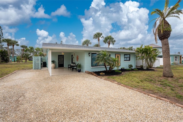 single story home featuring a front yard, fence, and driveway