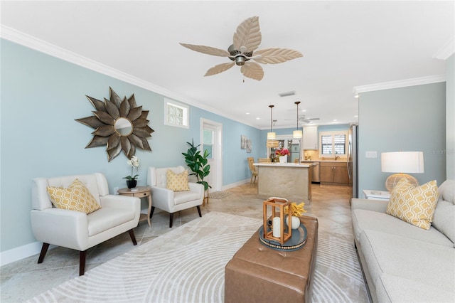 living area with light tile patterned floors, baseboards, crown molding, and ceiling fan