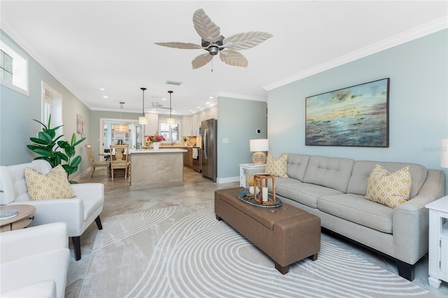 living area featuring recessed lighting, a ceiling fan, baseboards, and ornamental molding