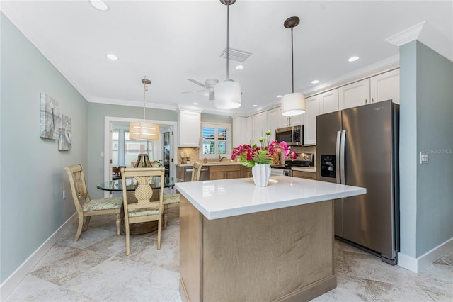 kitchen with stainless steel appliances, tasteful backsplash, white cabinets, and ornamental molding