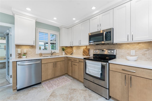 kitchen featuring light countertops, appliances with stainless steel finishes, and a sink