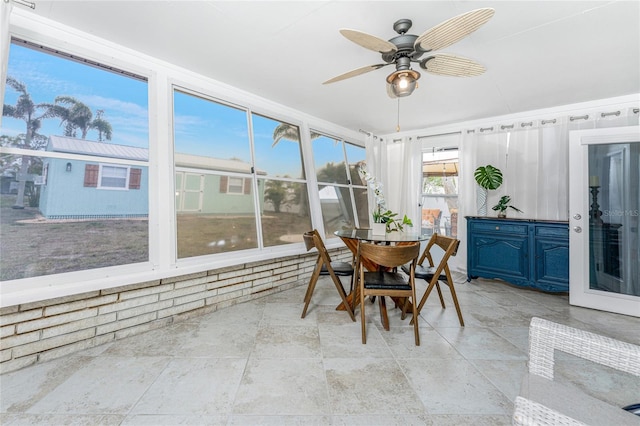 sunroom featuring a ceiling fan