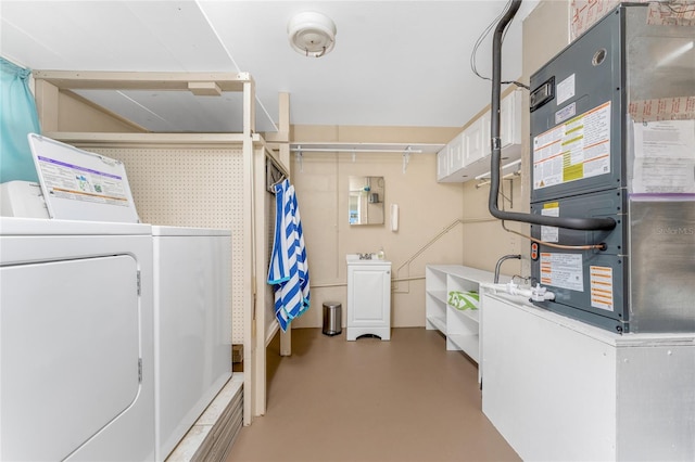 washroom with heating unit, laundry area, and separate washer and dryer