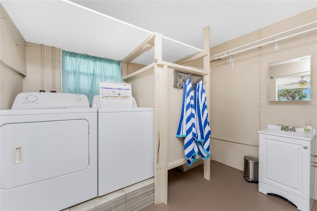 laundry room with laundry area, a sink, and separate washer and dryer