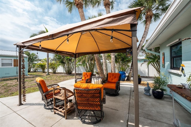 view of patio with a gazebo and fence