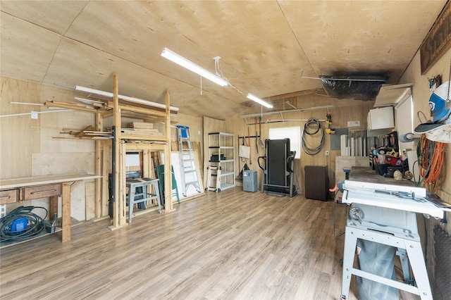 interior space featuring a workshop area and wood finished floors