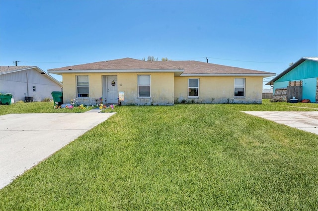 ranch-style house with central air condition unit, stucco siding, and a front yard