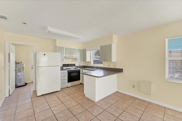 kitchen with a peninsula, water heater, freestanding refrigerator, electric stove, and under cabinet range hood