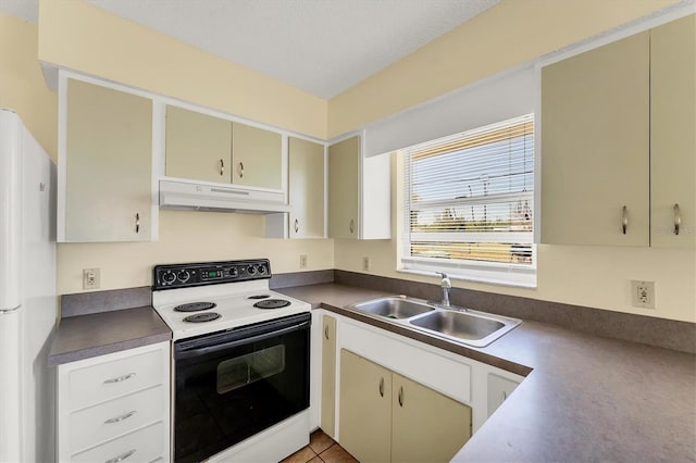 kitchen with dark countertops, under cabinet range hood, freestanding refrigerator, electric range, and a sink