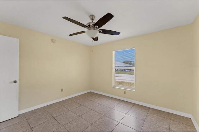 unfurnished room featuring light tile patterned flooring, ceiling fan, and baseboards