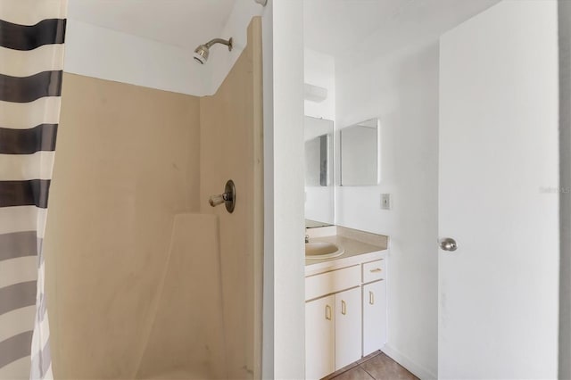 bathroom with curtained shower, tile patterned floors, and vanity