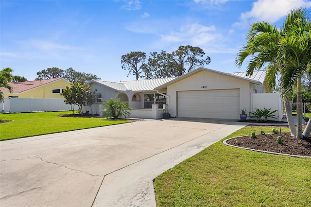 201 Cavallini Dr, Nokomis, FL 34275 - ranch-style house featuring a standing seam roof, metal roof, driveway, a front lawn, and a garage