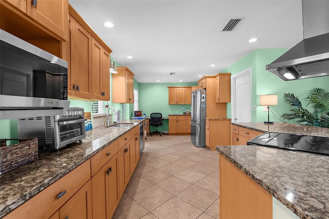 201 Cavallini Dr, Nokomis, FL 34275 - kitchen featuring a sink, appliances with stainless steel finishes, wall chimney range hood, visible vents, and dark stone counters