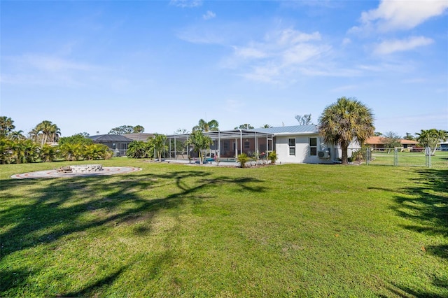 201 Cavallini Dr, Nokomis, FL 34275 - view of yard featuring glass enclosure, a fire pit, and fence