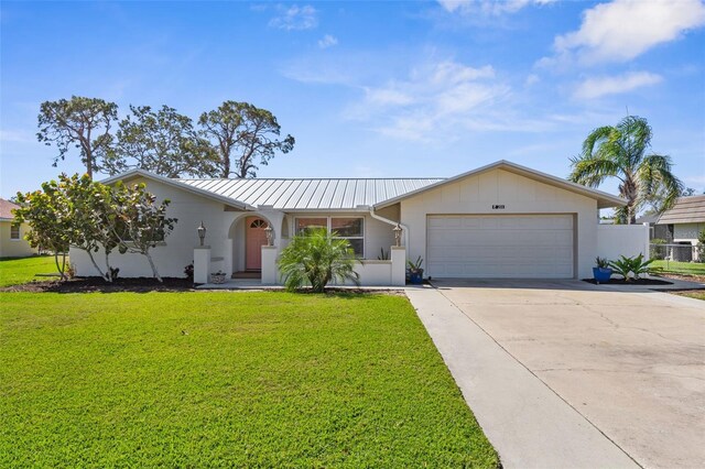 201 Cavallini Dr, Nokomis, FL 34275 - single story home with concrete driveway, fence, a front lawn, metal roof, and a garage