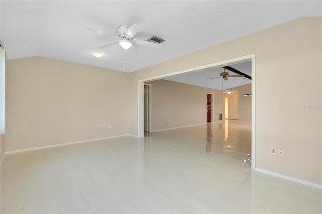 empty room with lofted ceiling, baseboards, visible vents, and ceiling fan