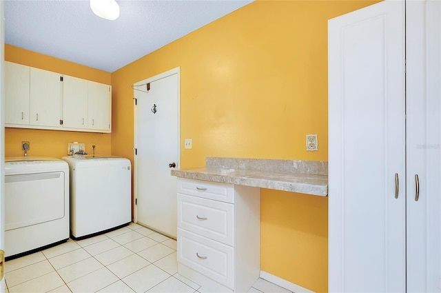 washroom with cabinet space, light tile patterned flooring, and separate washer and dryer