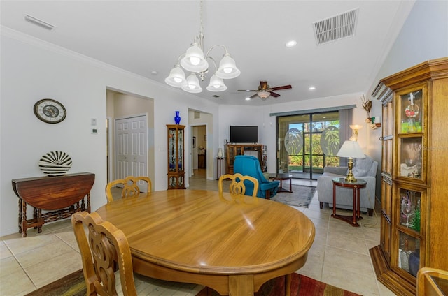 dining space featuring light tile patterned floors, visible vents, ceiling fan with notable chandelier, and crown molding