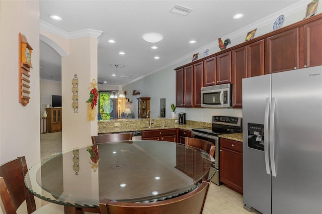 kitchen featuring stainless steel appliances, dark brown cabinets, crown molding, and visible vents