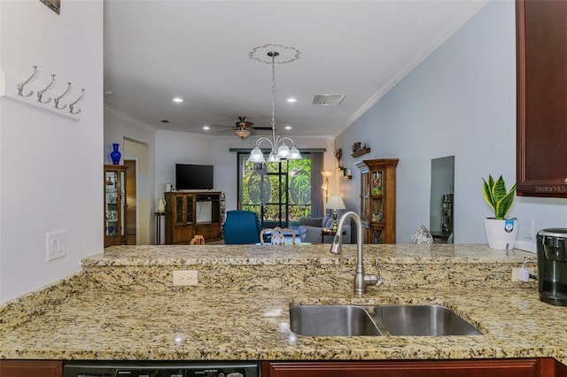 kitchen with ceiling fan, light stone countertops, open floor plan, and a sink