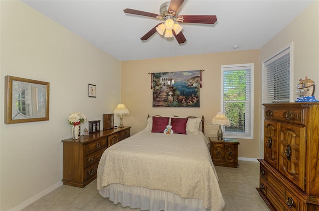 bedroom with light tile patterned floors, baseboards, and ceiling fan