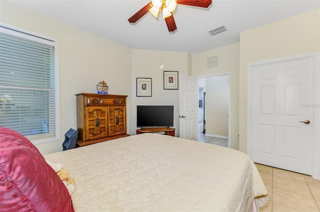 bedroom featuring ceiling fan, visible vents, and light tile patterned flooring