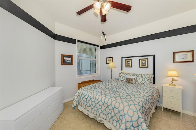 tiled bedroom featuring baseboards and ceiling fan