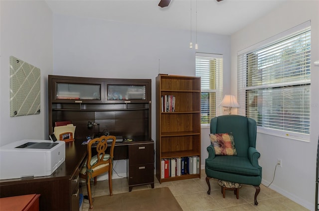 office space with tile patterned flooring, ceiling fan, and baseboards