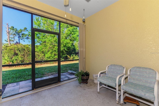 sunroom / solarium with plenty of natural light and a ceiling fan